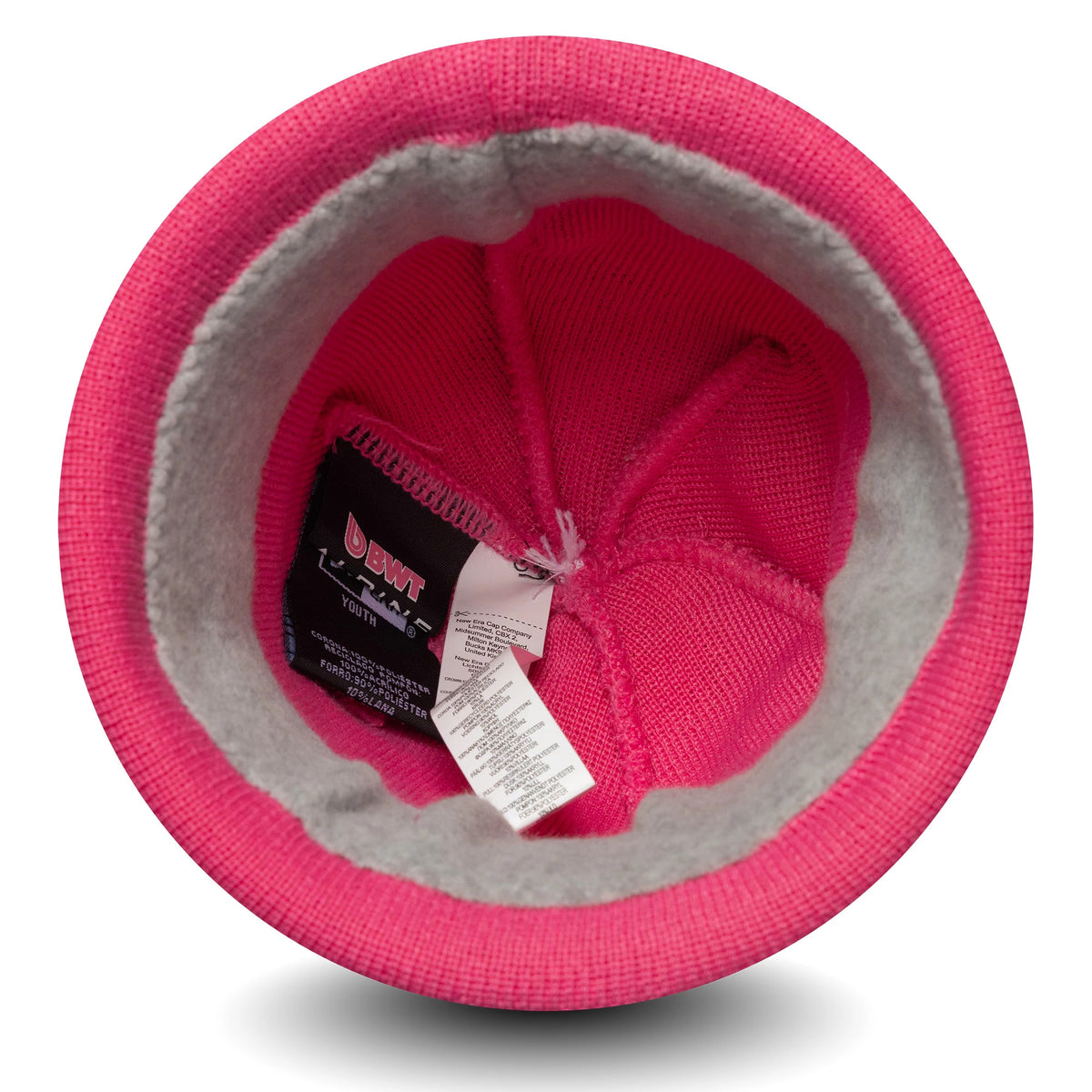 New Era Alpine Racing Youth Replica Jack Doohan Pink Cuff Knit Beanie Hat, inside view showing the grey lining and woven labels, with detailed pink knit construction and care instruction tags attached.