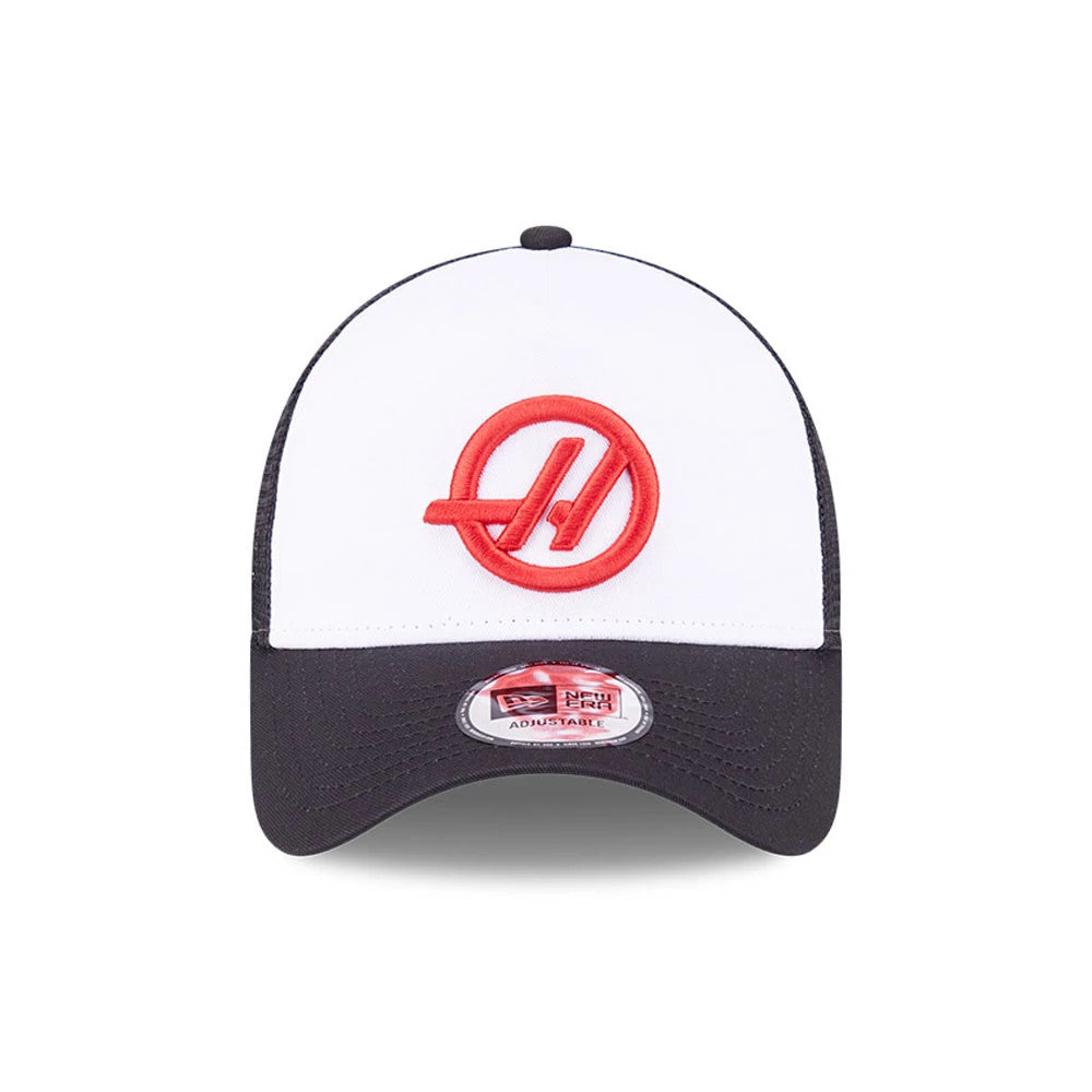 TGR Haas F1 Black New Era 9FORTY E-Frame Trucker Adjustable Cap, front view showing raised red Haas logo embroidered on the white front panel, with a curved black visor and 9FORTY size sticker.