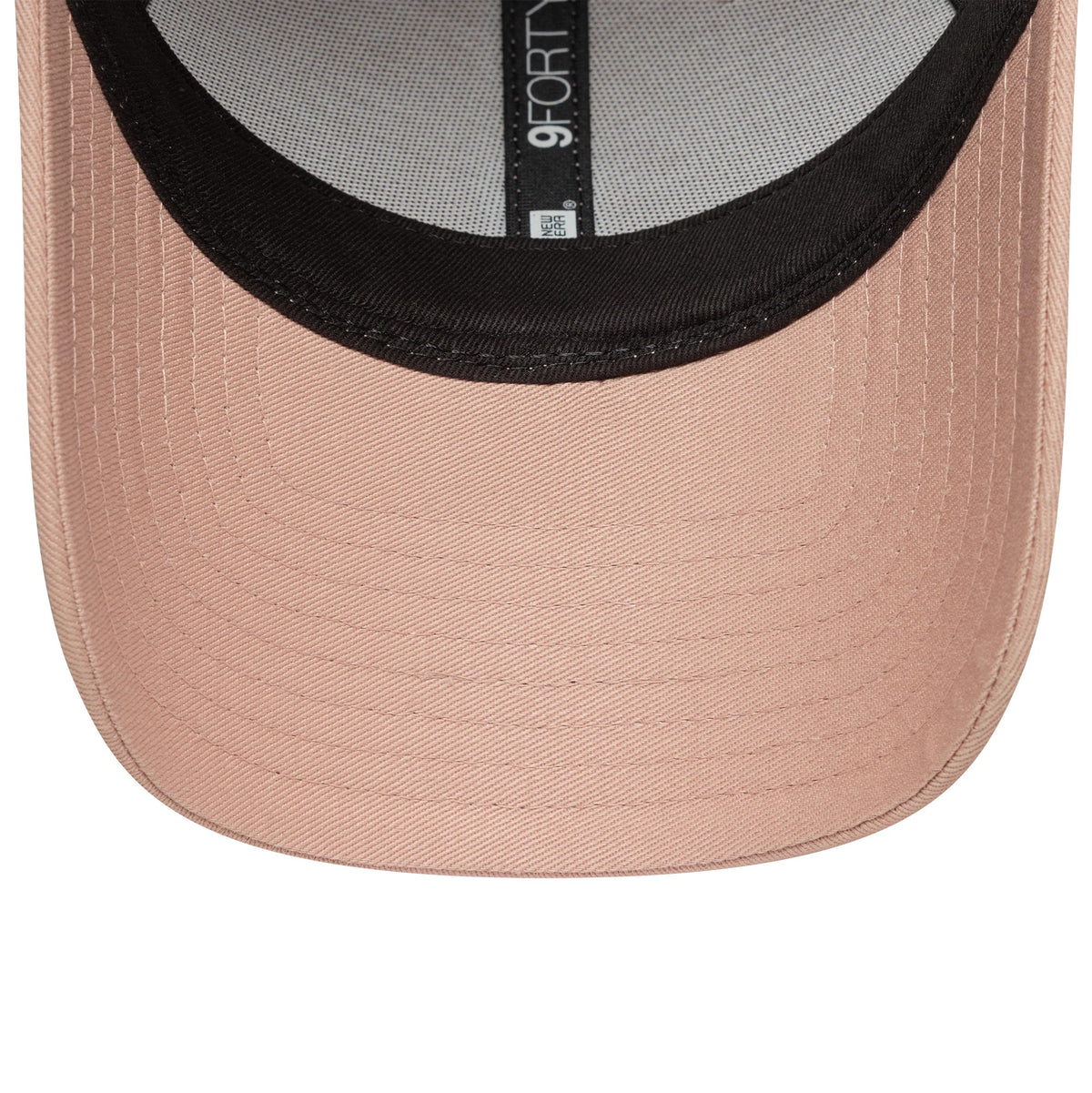 New York Yankees Womens MLB Mini Logo Pastel Pink New Era 9FORTY Adjustable Cap, inside view showing a grey sweatband with black taping and a 9FORTY size sticker on the underside of the pink visor.