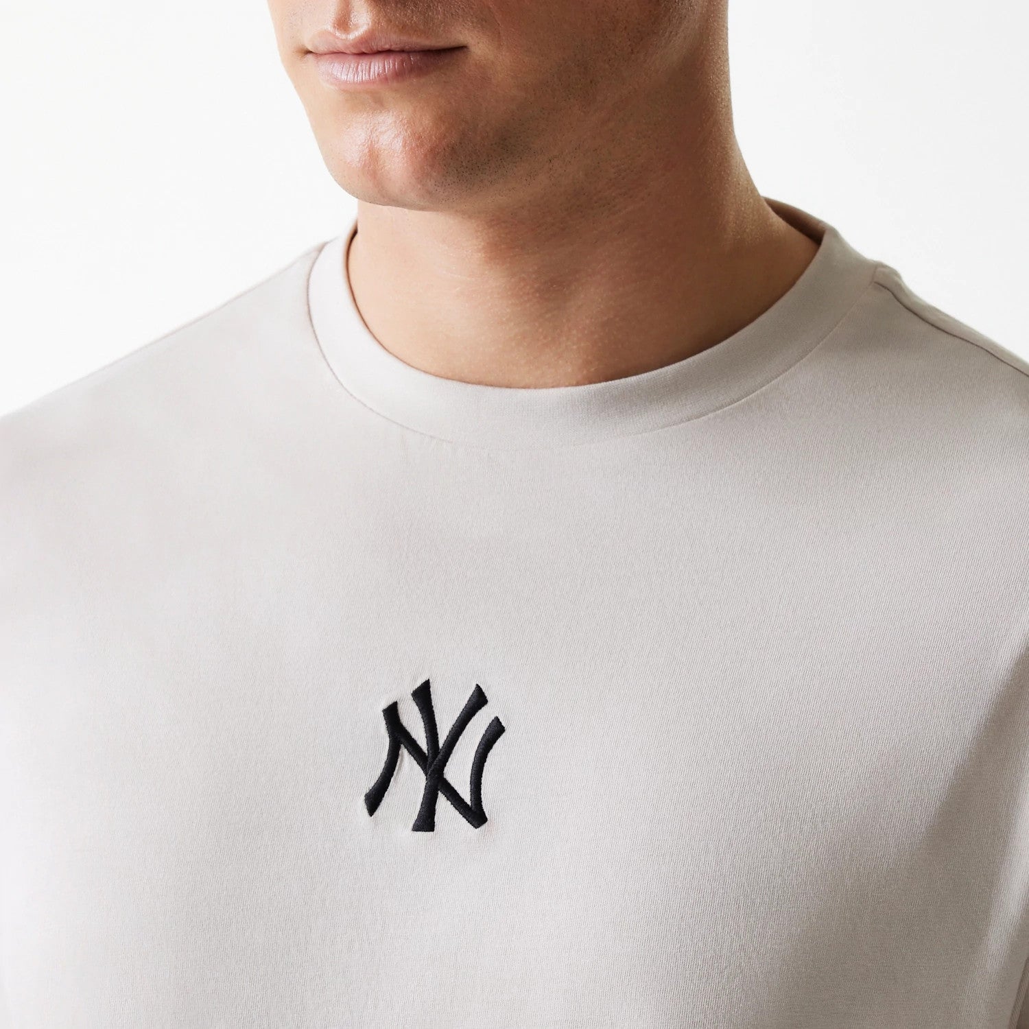 The Male model is wearing New York Yankees MLB League Essential Cream Oversized T-Shirt 4