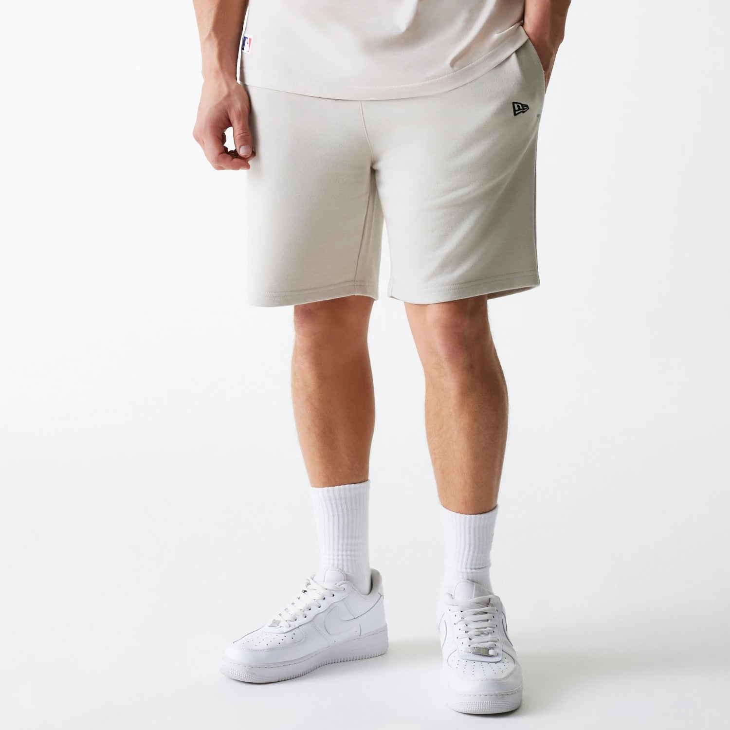 The Male model is wearing New York Yankees MLB League Essential Cream Shorts 1