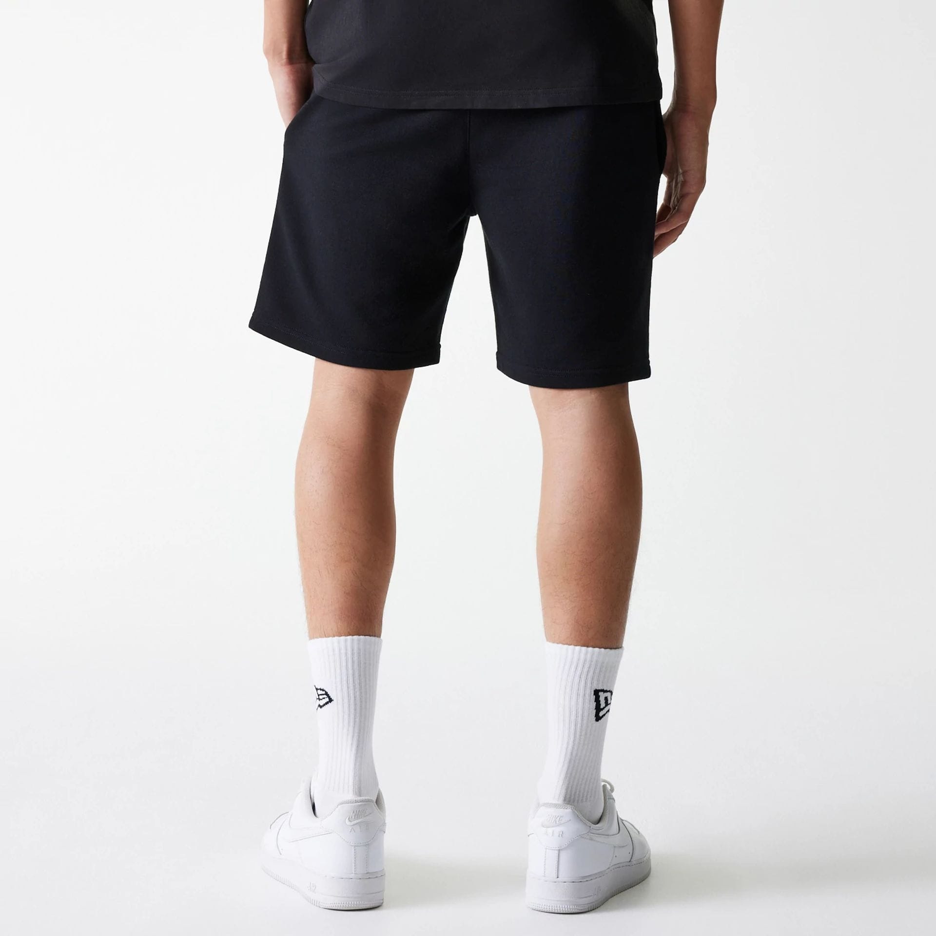 The Male model is wearing New York Yankees MLB League Essential Black Shorts 2