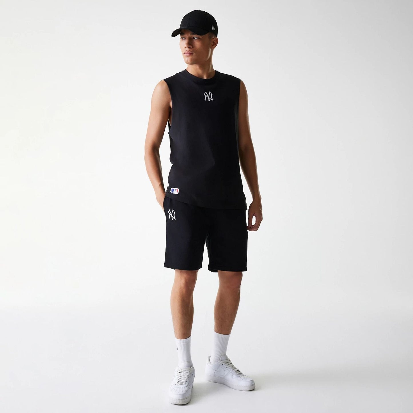 The Male model is wearing New York Yankees MLB League Essential Black Shorts 8