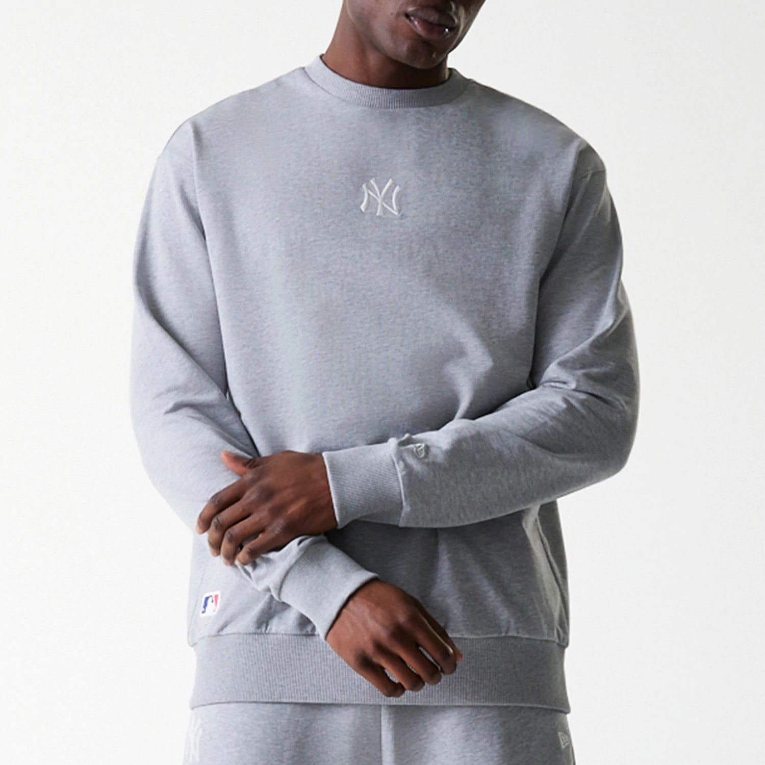 The Male model is wearing New York Yankees MLB League Essential Grey Crew Neck Sweater. 3