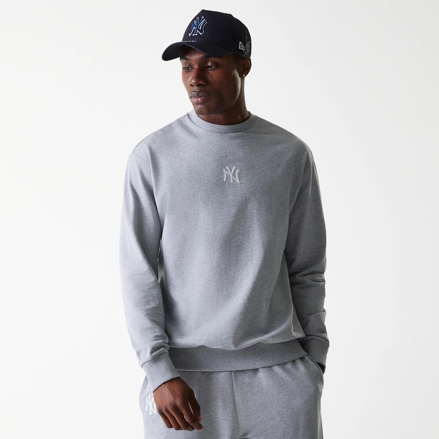 The Male model is wearing New York Yankees MLB League Essential Grey Crew Neck Sweater. 1