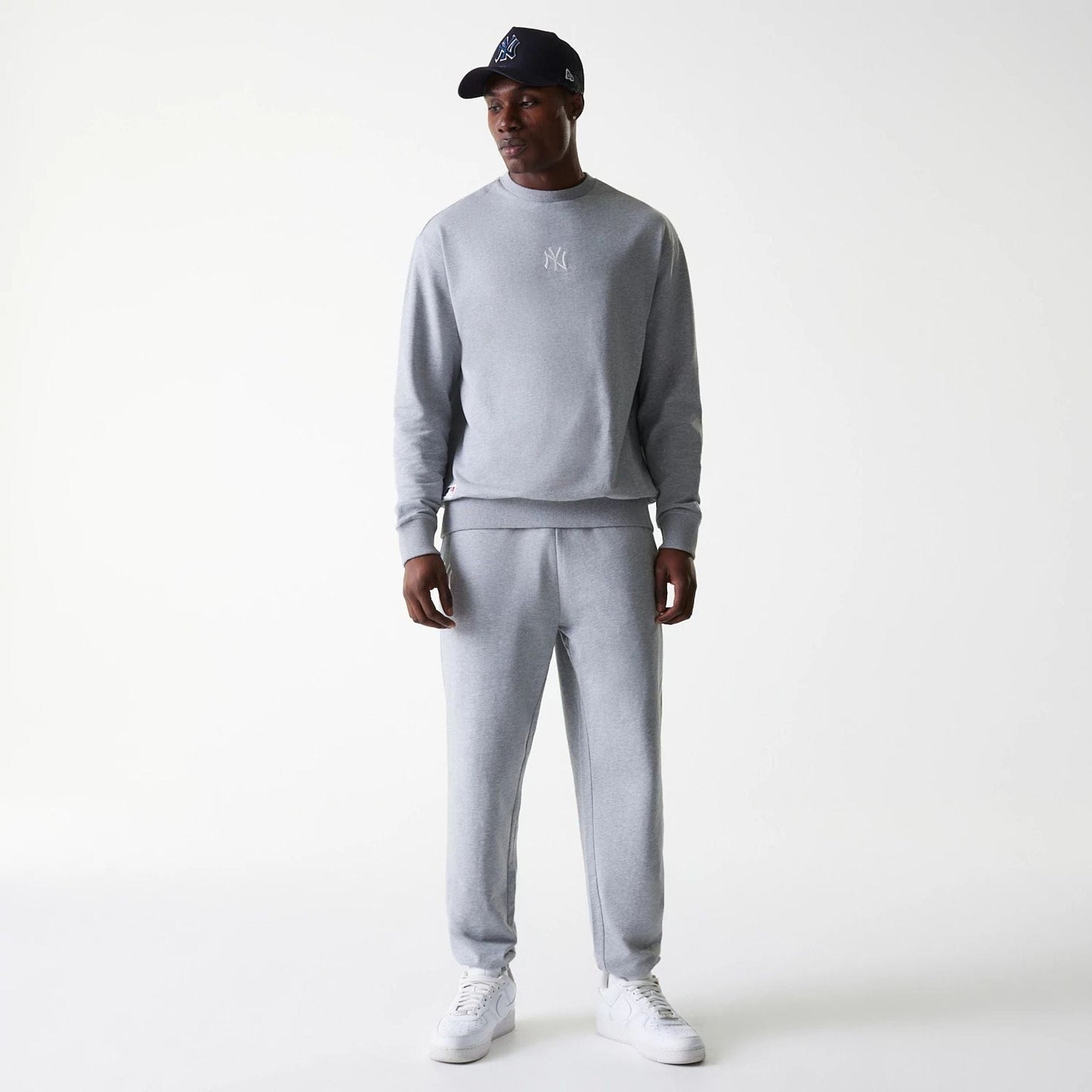 The Male model is wearing New York Yankees MLB League Essential Midi Grey Joggers 8