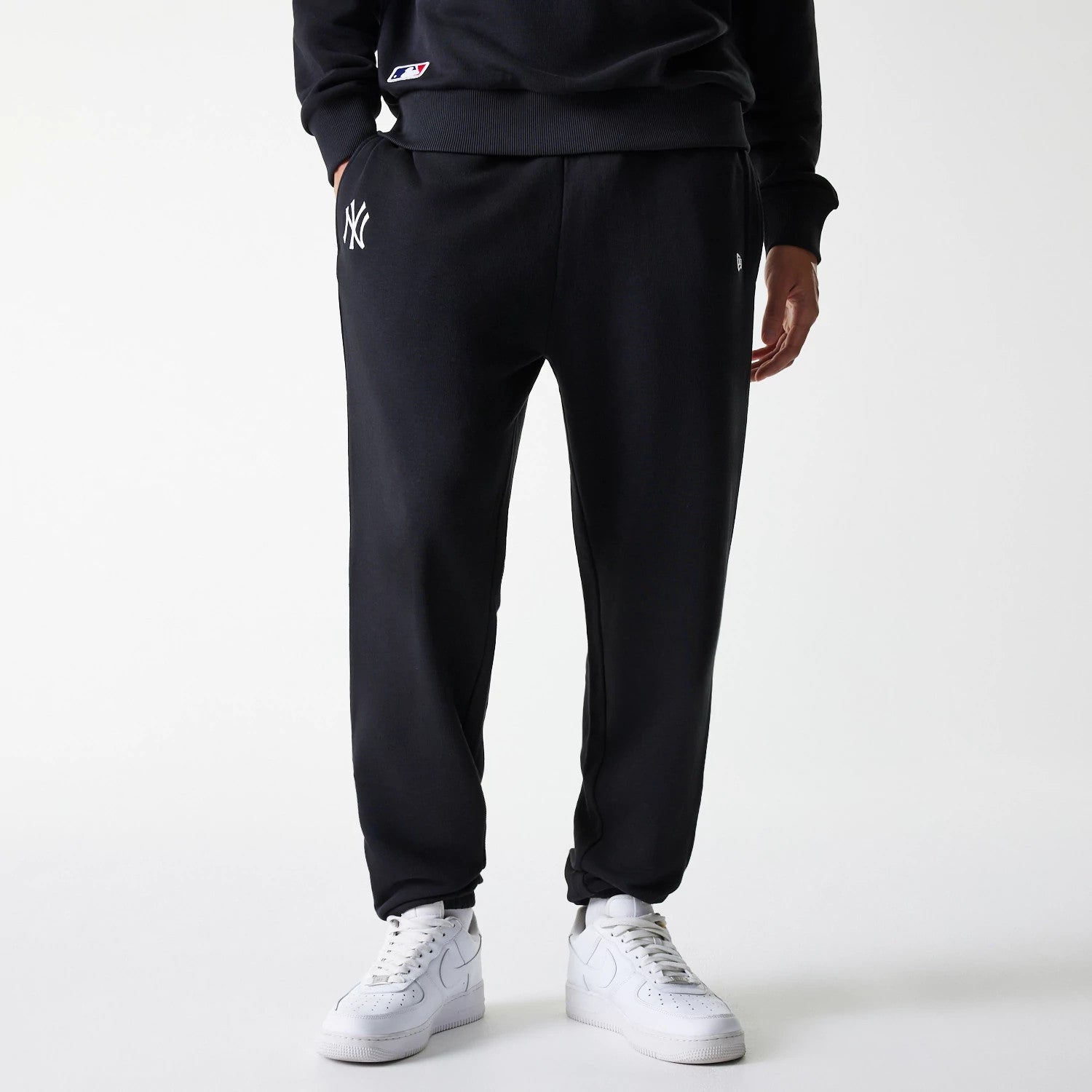 The Male model is wearing New York Yankees MLB League Essential Black Joggers 1
