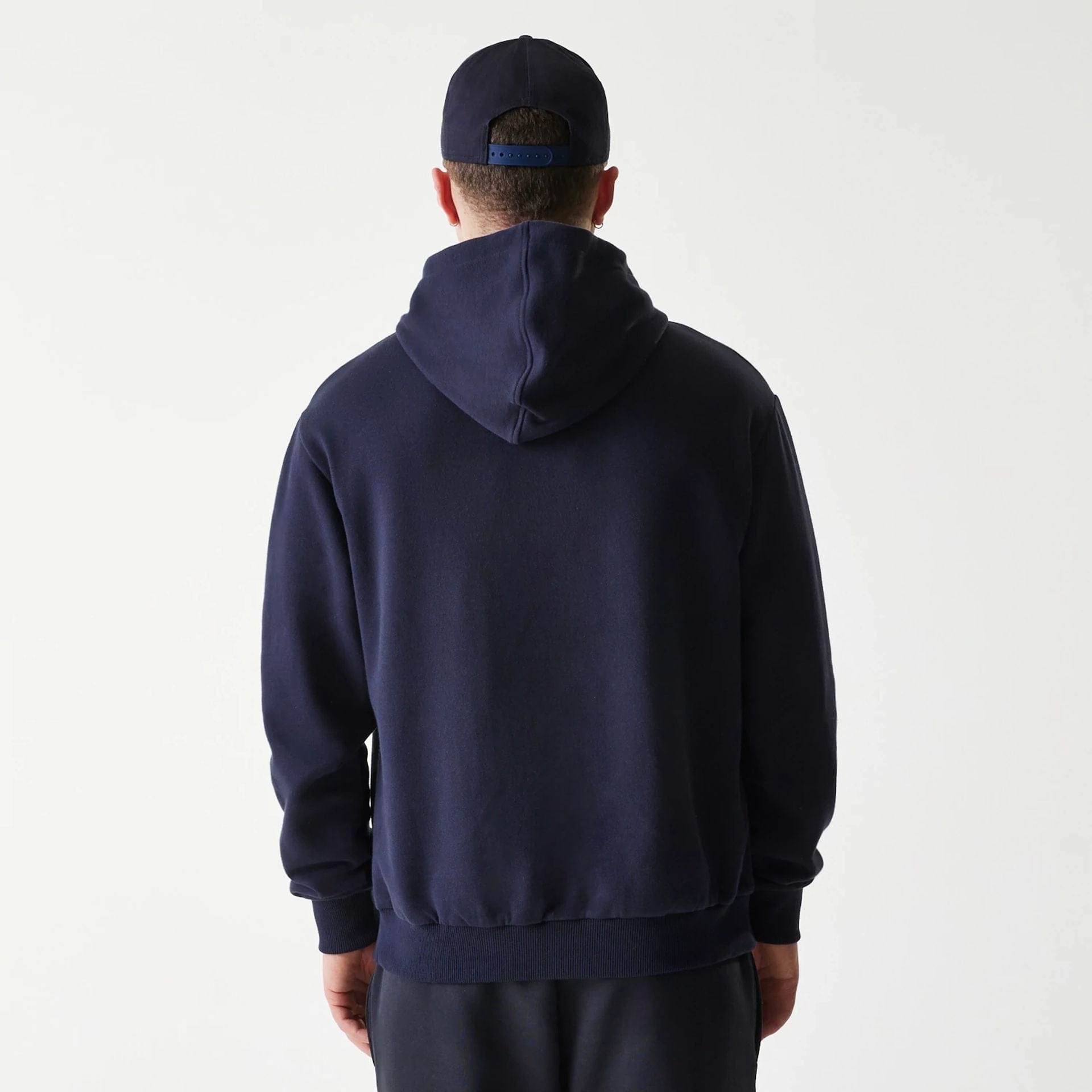 The Male model is wearing New York Yankees MLB League Essential Navy Oversized Pullover Hoodie 2
