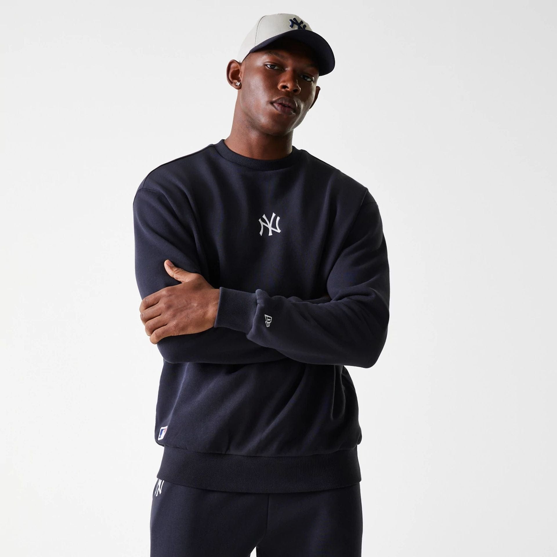 The Male model is wearing New York Yankees MLB League Essential Midi Navy Oversized Crew Neck Sweater 1