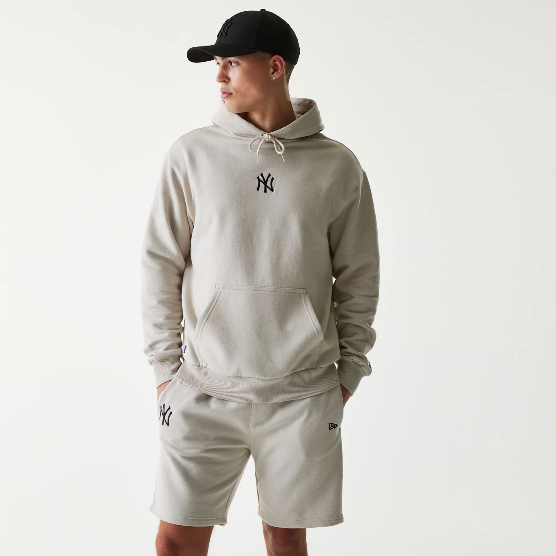 The Male model is wearing New York Yankees MLB League Essential Cream Oversized Pullover Hoodie 1