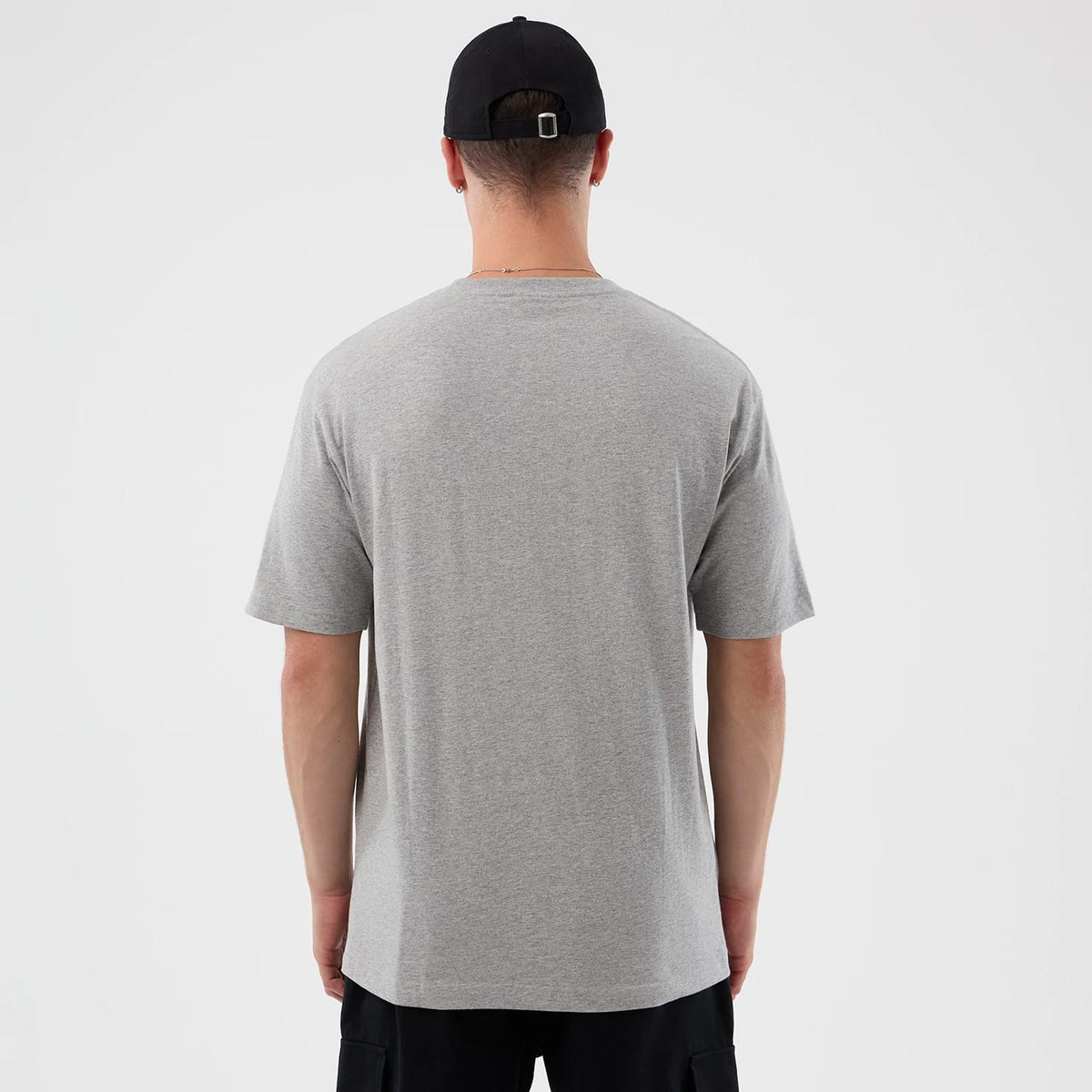 New Era Detroit Red Wings NHL Sport Classic Grey T-Shirt, rear view showing the plain grey back of the T-shirt with short sleeves extending from the shoulders, worn by a model wearing a black cap.