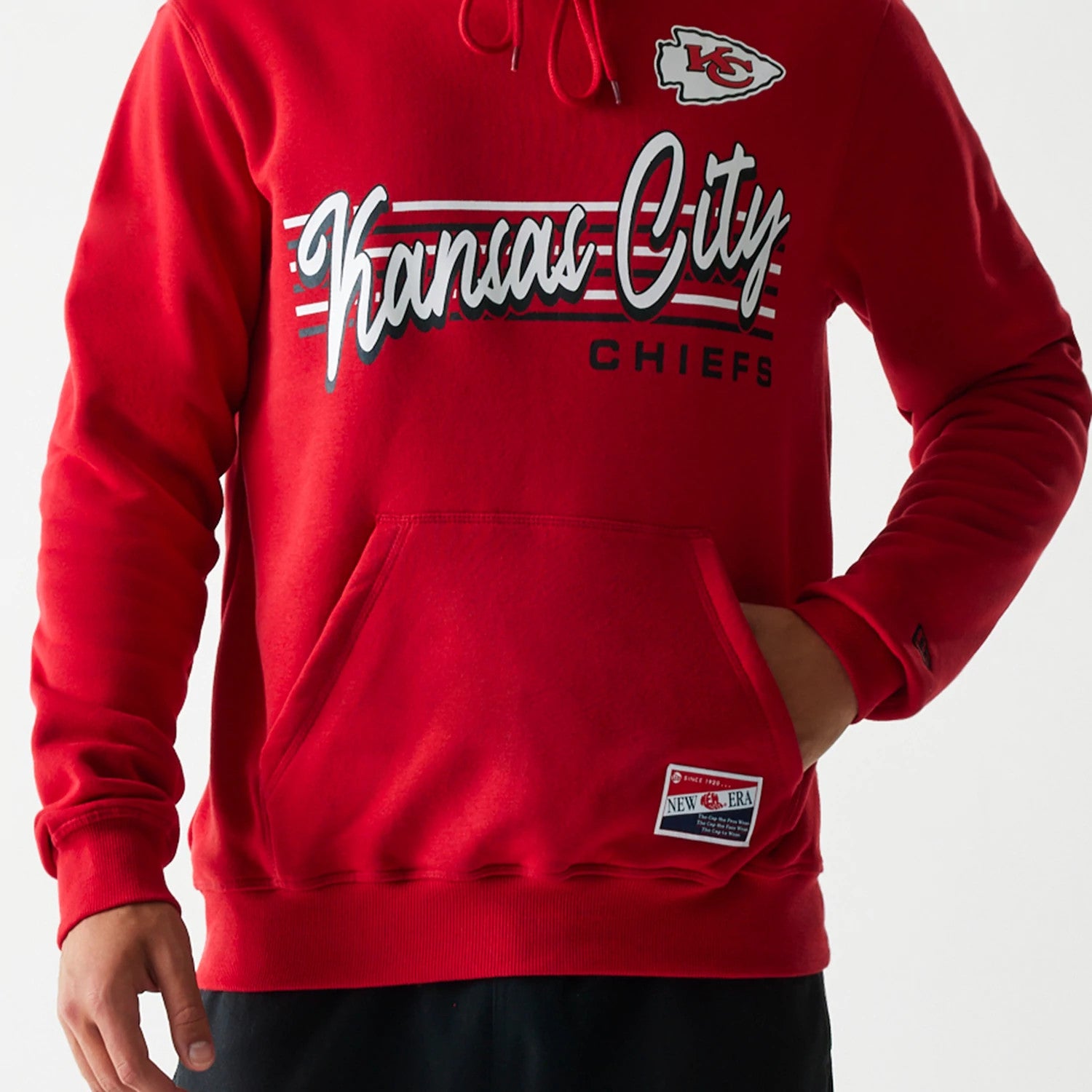 New Era Kansas City Chiefs NFL Throwback Red Pullover Hoodie, front view showing the embroidered Chiefs logo on the chest, Kansas City script across the front, a drawstring hood, and a New Era tag on the lower pocket.