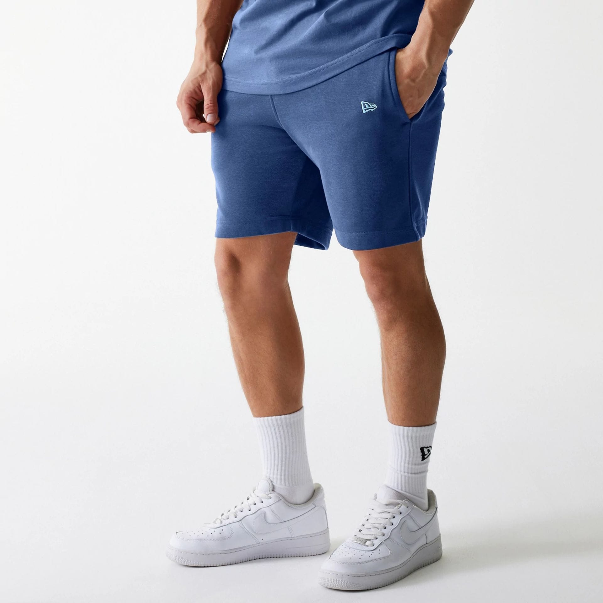 The Male model is wearing LA Dodgers MLB Midi League Essential Dark Blue Shorts 1