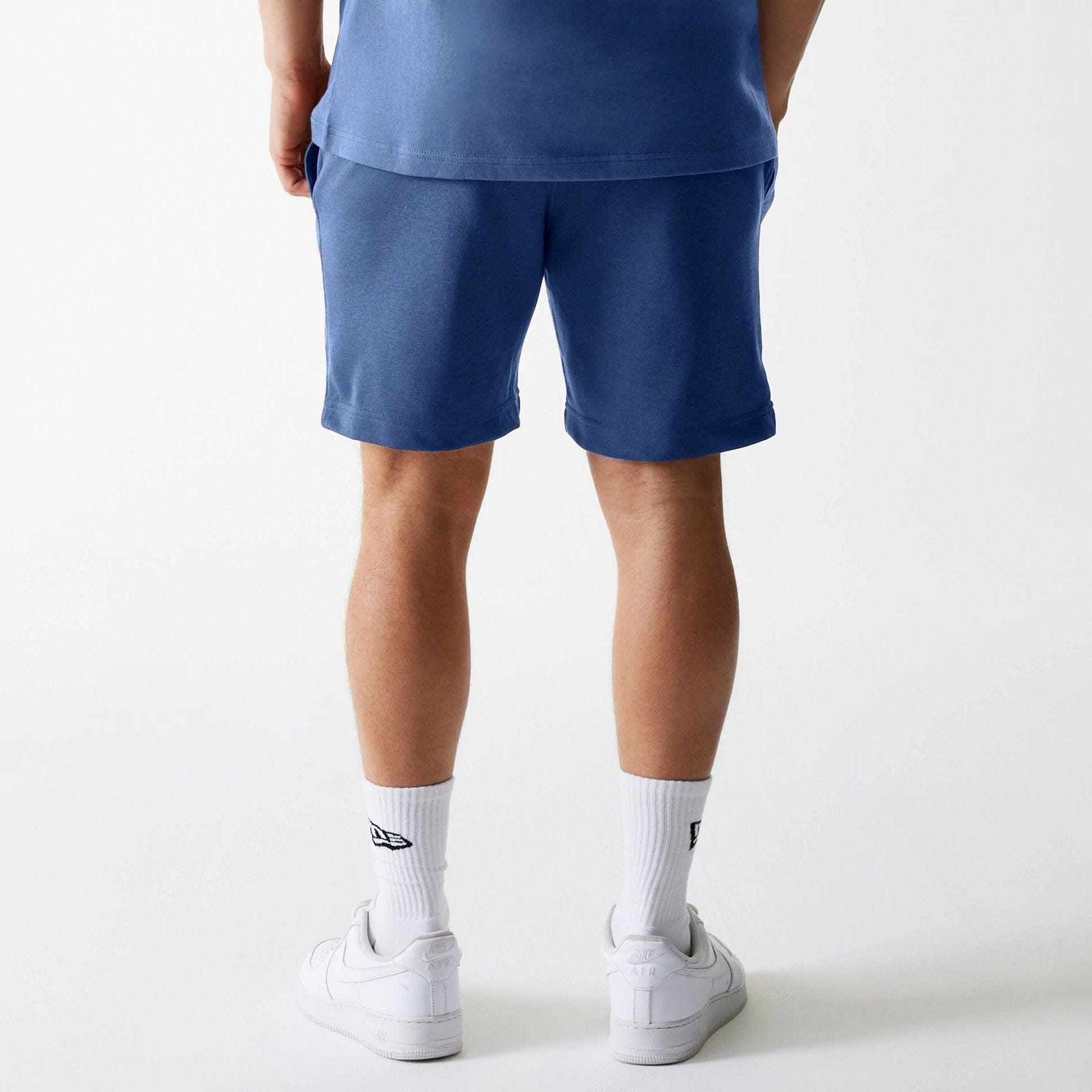 The Male model is wearing LA Dodgers MLB Midi League Essential Dark Blue Shorts 2