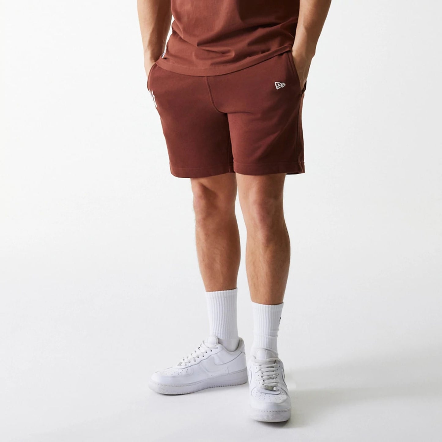 The Male model is wearing New York Yankees MLB Midi League Essential Brown Shorts 6