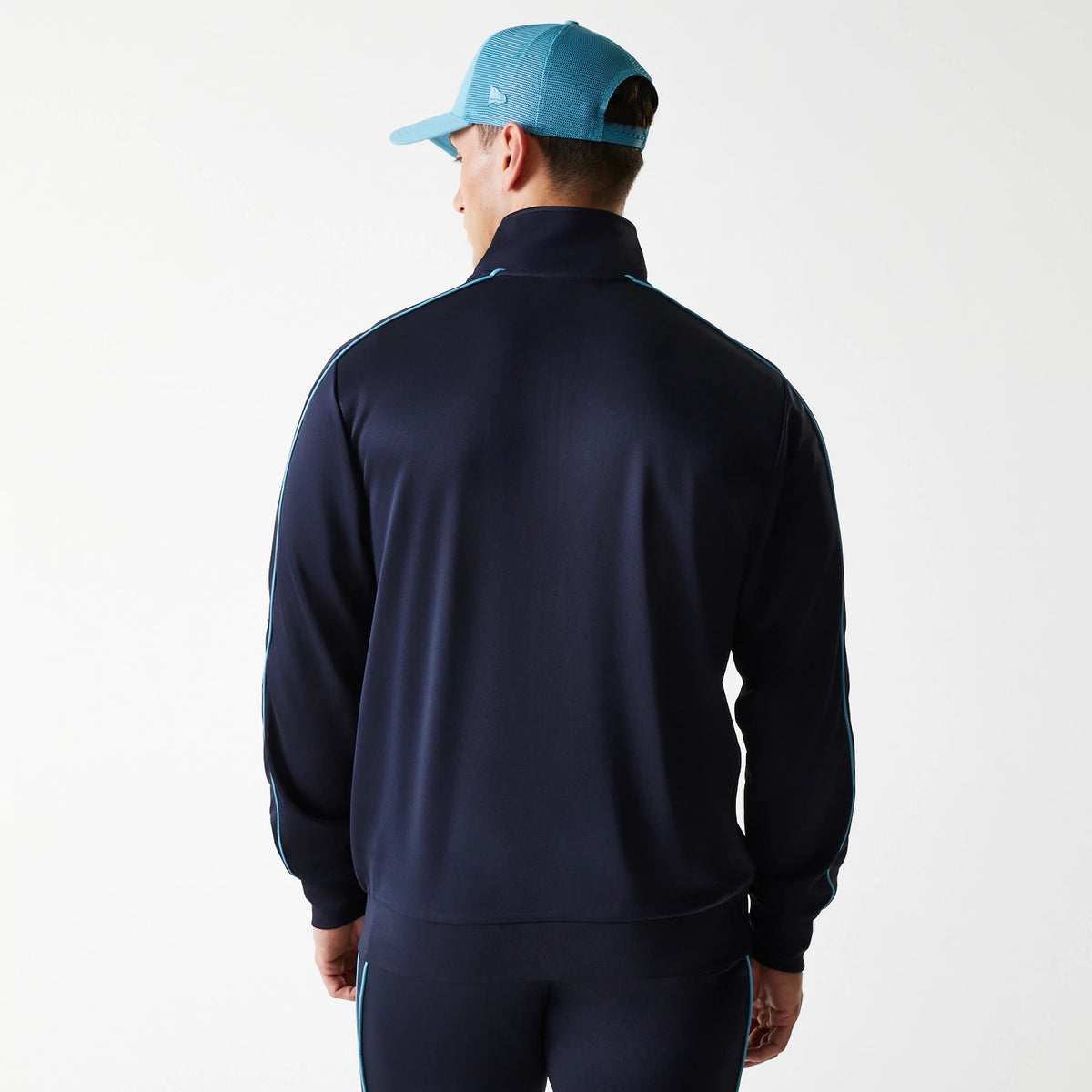 New Era LA Dodgers MLB Navy Track Top, rear view on a model wearing a light blue mesh cap, showing light blue piping along the sleeves and the high collar design on the dark navy top.