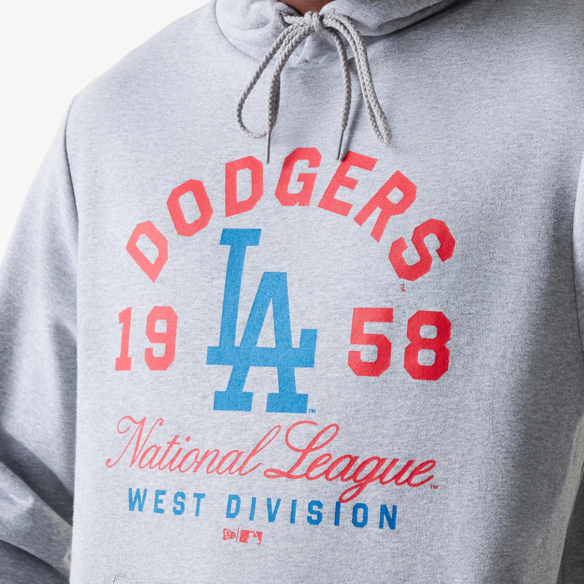 New Era LA Dodgers MLB Wordmark Grey Pullover Hoodie, front view showing the large printed Dodgers logo in red and blue across the chest, with the text 'National League West Division' below, and grey drawstrings at the neck.