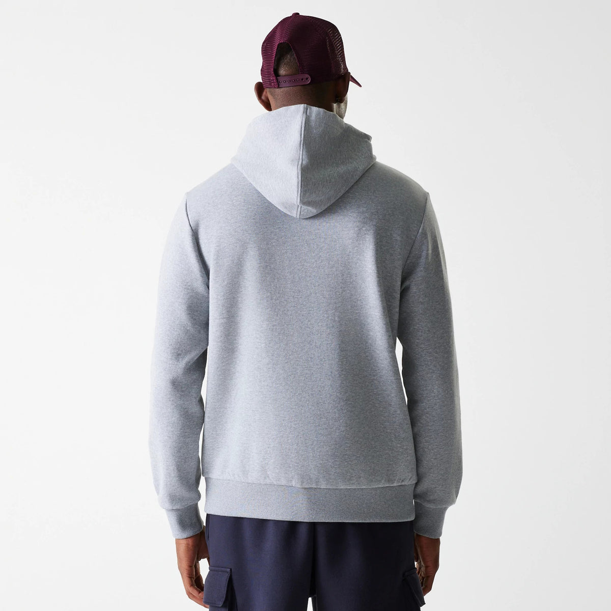 New Era LA Dodgers MLB Wordmark Grey Pullover Hoodie, rear view showing the plain grey back with a large hood and ribbed waistband, worn by a person in a purple cap.