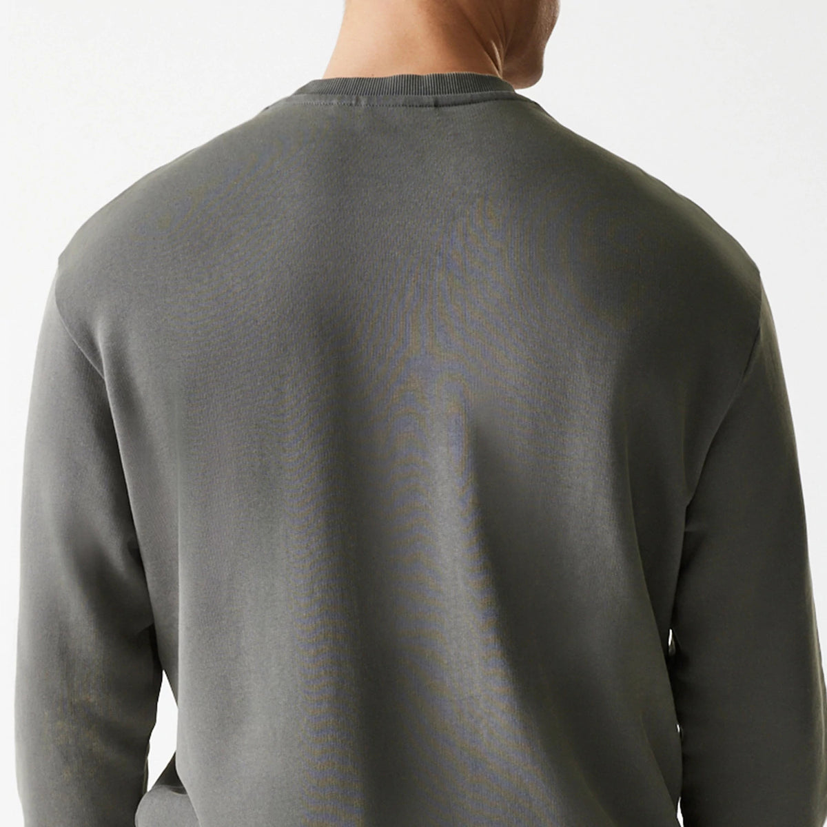 New Era San Francisco 49ers NFL Washed Super Bowl Grey Oversized Crew Neck Sweater, back view on a model showing the washed grey fabric with long sleeves and a ribbed crew neck, seamlessly fitting the shoulders.