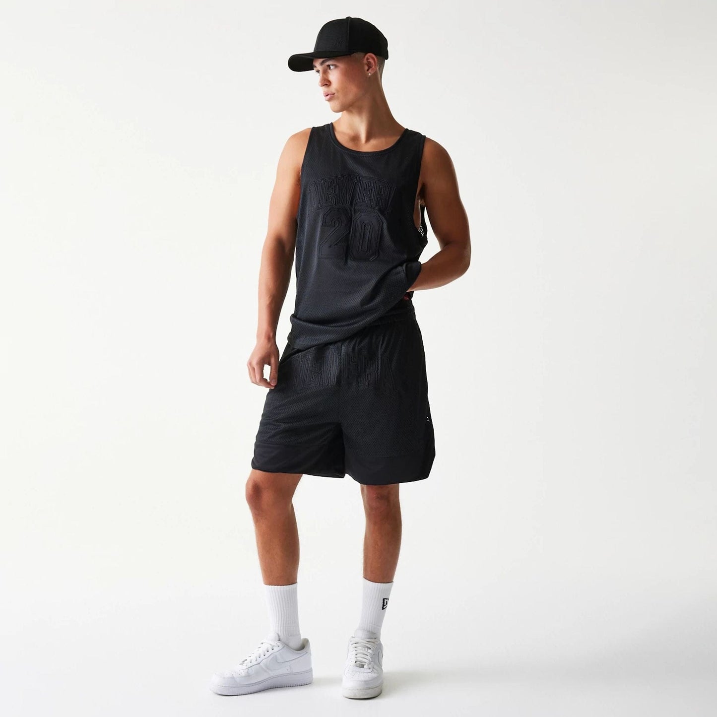 The Male model is wearing New Era Mesh Black Shorts 6