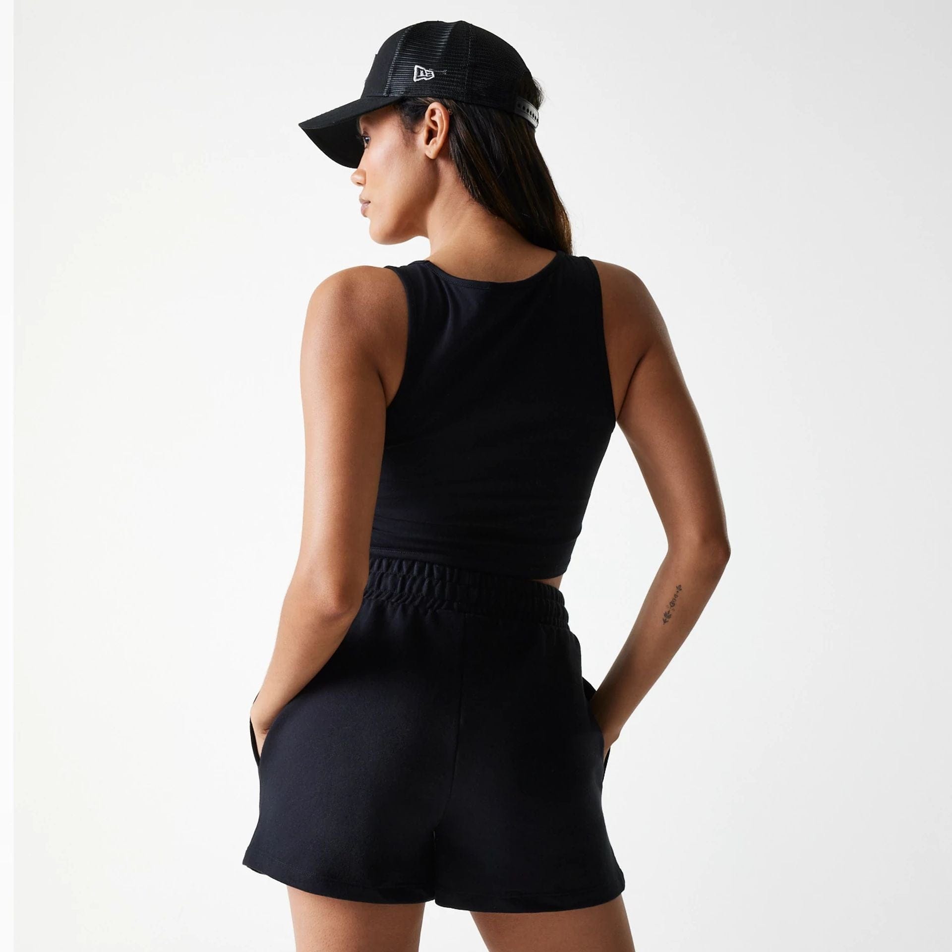 The Female model is wearing New York Yankees Womens MLB Midi League Essential Black Shorts 2