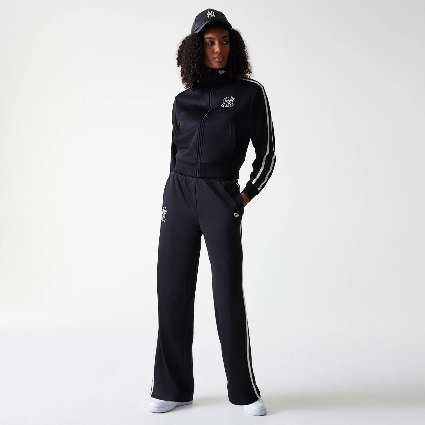 The Female model is wearing New York Yankees Womens MLB Midi Logo Black Track Pants 8