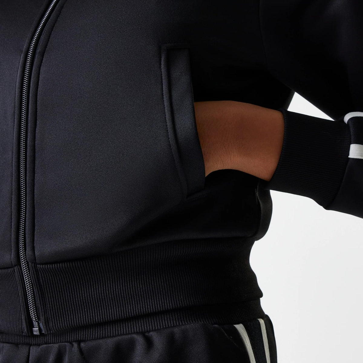 The Female model is wearing New York Yankees Womens MLB Midi Logo Black Track Jacket 4