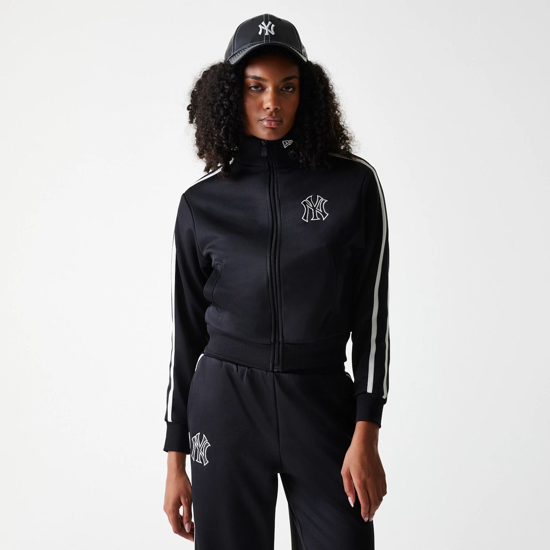 The Female model is wearing New York Yankees Womens MLB Midi Logo Black Track Jacket 1