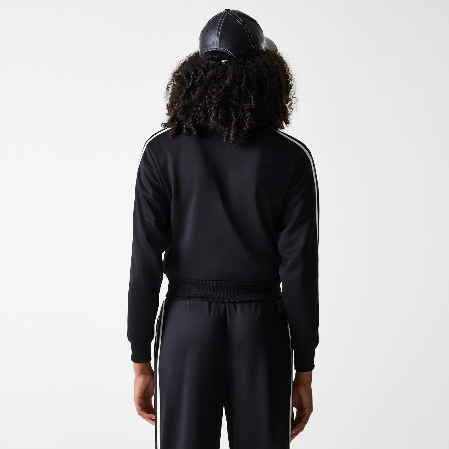 The Female model is wearing New York Yankees Womens MLB Midi Logo Black Track Jacket 2