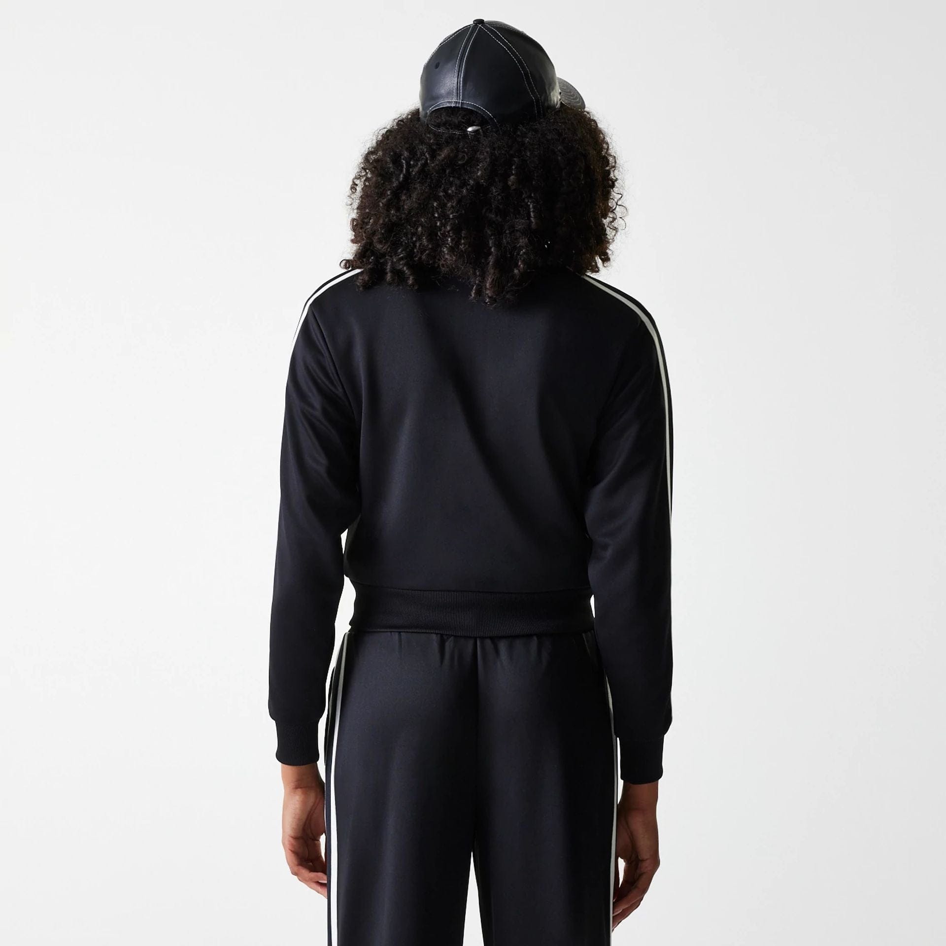 The Female model is wearing New York Yankees Womens MLB Midi Logo Black Track Jacket 2