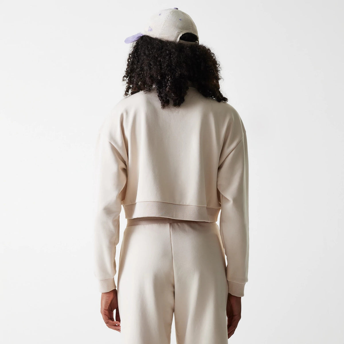 New Era LA Dodgers Womens MLB Tonal Light Beige Cropped 1/4 Zip Sweater, back view on a model with matching light beige joggers, showcasing a relaxed fit and a ribbed hem for casual styling.