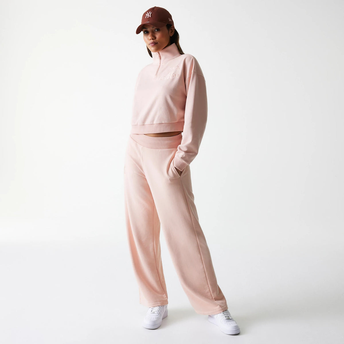 New Era New York Yankees Womens MLB Tonal Pastel Pink Cropped 1/4 Zip Sweater, on a model styled with matching pink joggers and white trainers, featuring subtle embroidered logo on the chest and a relaxed fit for casual comfort.