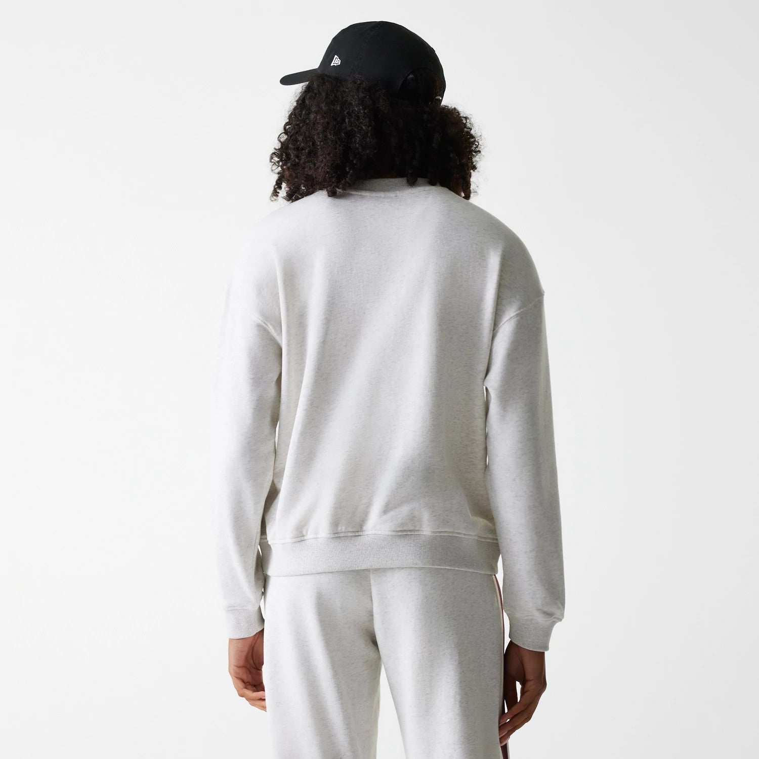 The Female model is wearing Womens New Era Crest Graphic Pastel Grey Crew Neck Sweater 2