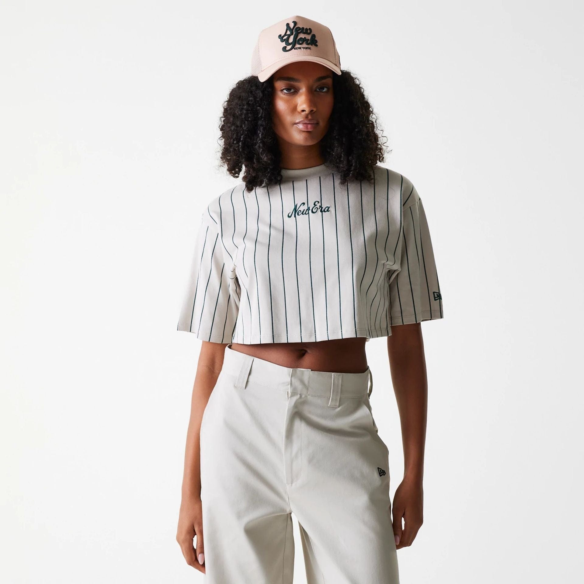 The Female model is wearing Womens New Era Pinstripe Light Beige Crop T-Shirt 1