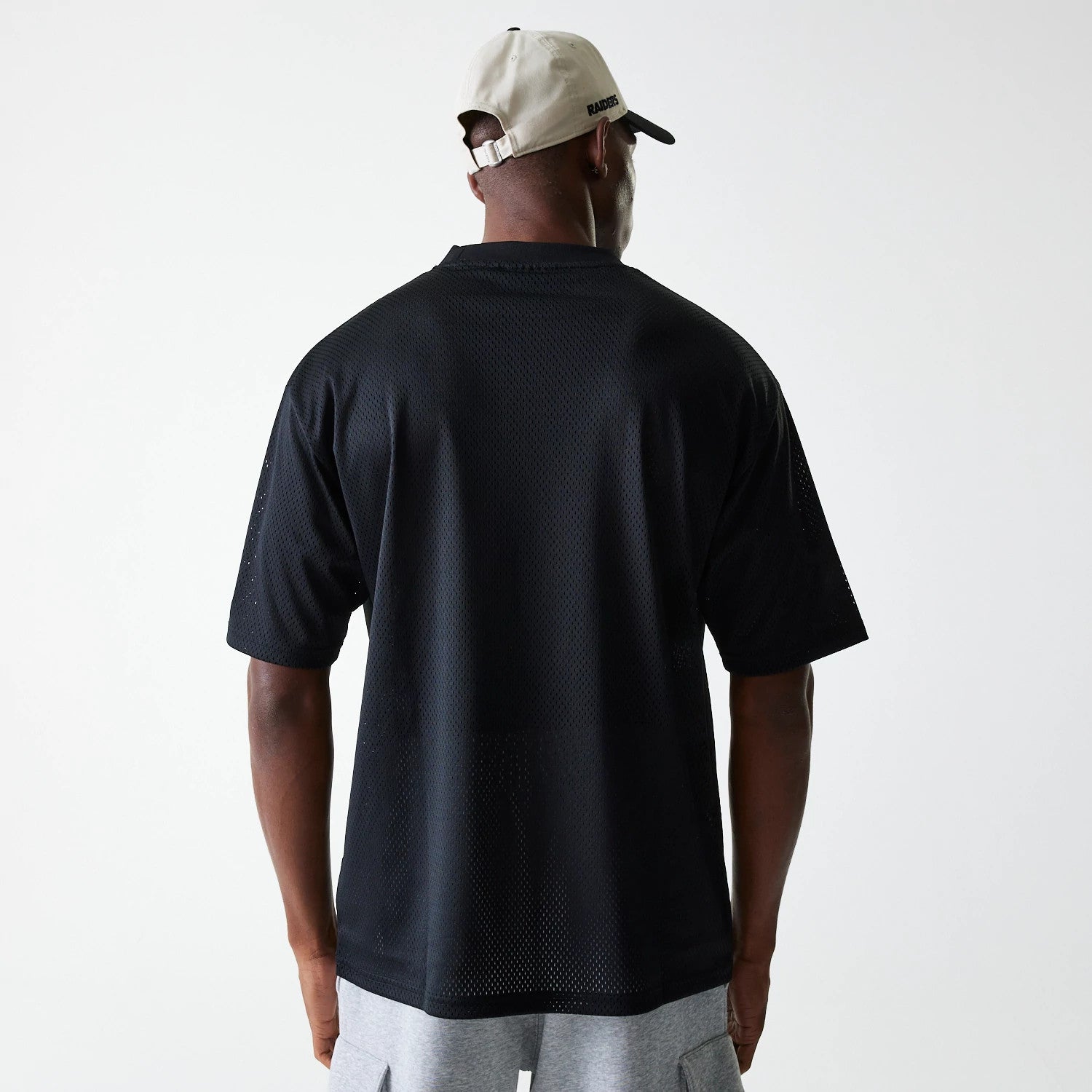 The Male model is wearing Las Vegas Raiders NFL Essentials Black Oversized Mesh T-Shirt 2