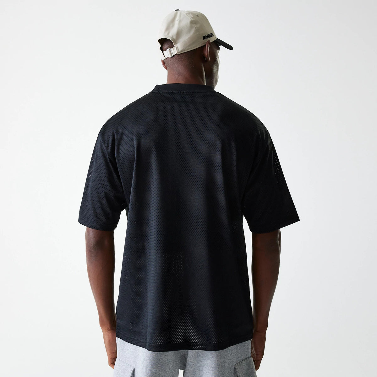 The Male model is wearing Las Vegas Raiders NFL Essentials Black Oversized Mesh T-Shirt 2