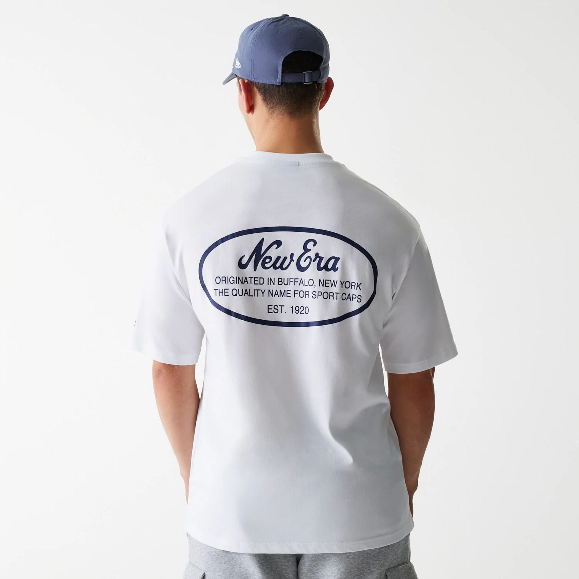 The Male model is wearing New Era Trucker Patch White Oversized T-Shirt 2
