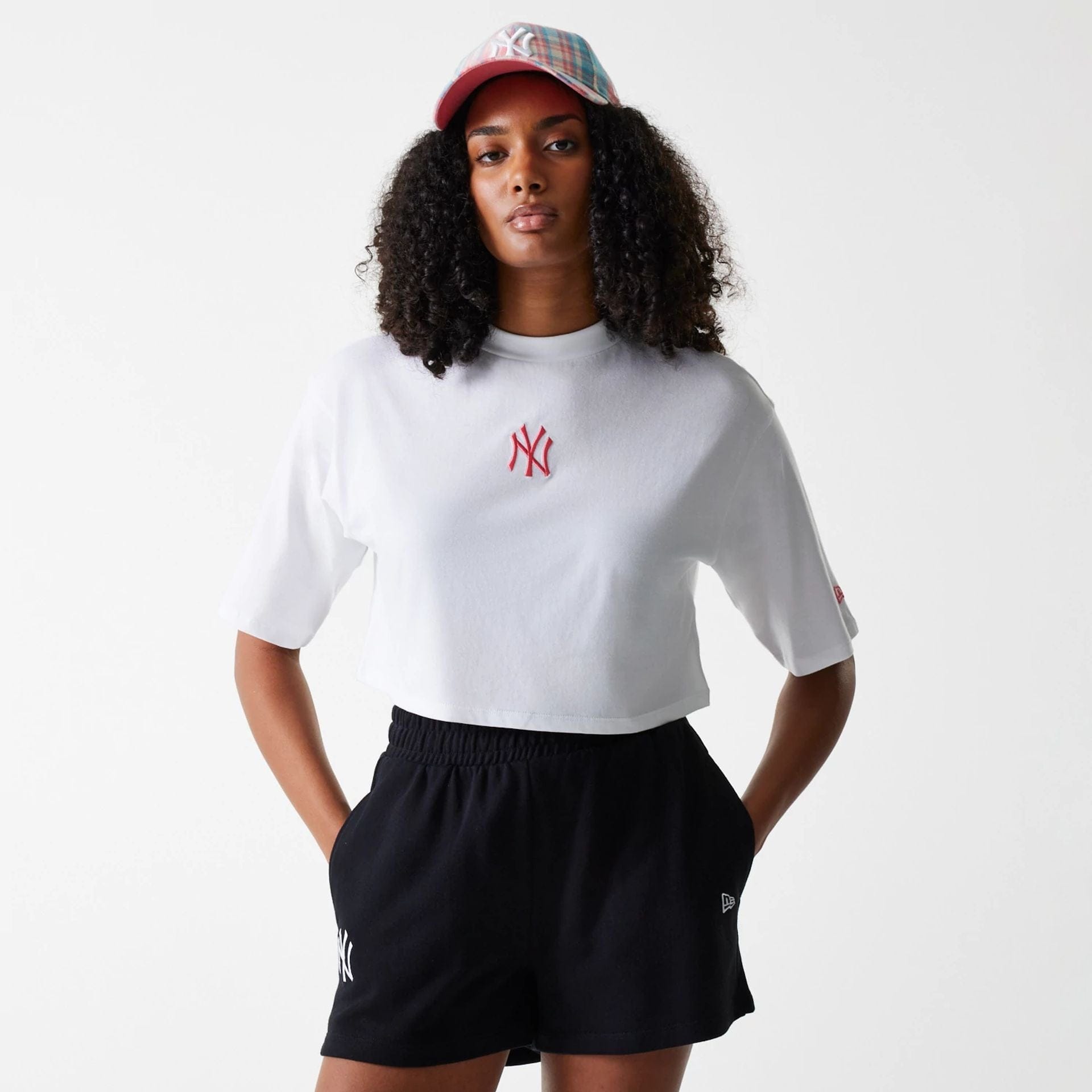 The Female model is wearing New York Yankees Womens League Essential Midi White Crop T-Shirt 1