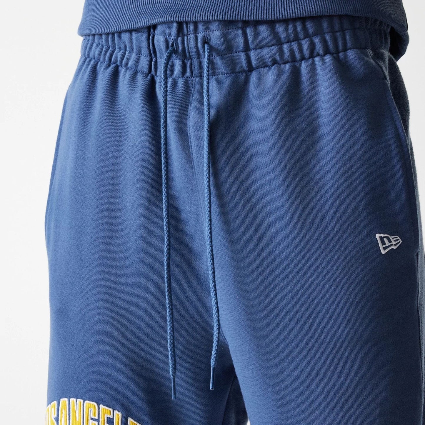 The Male model is wearing LA Lakers NBA Arch Graphic Dark Blue Joggers 8