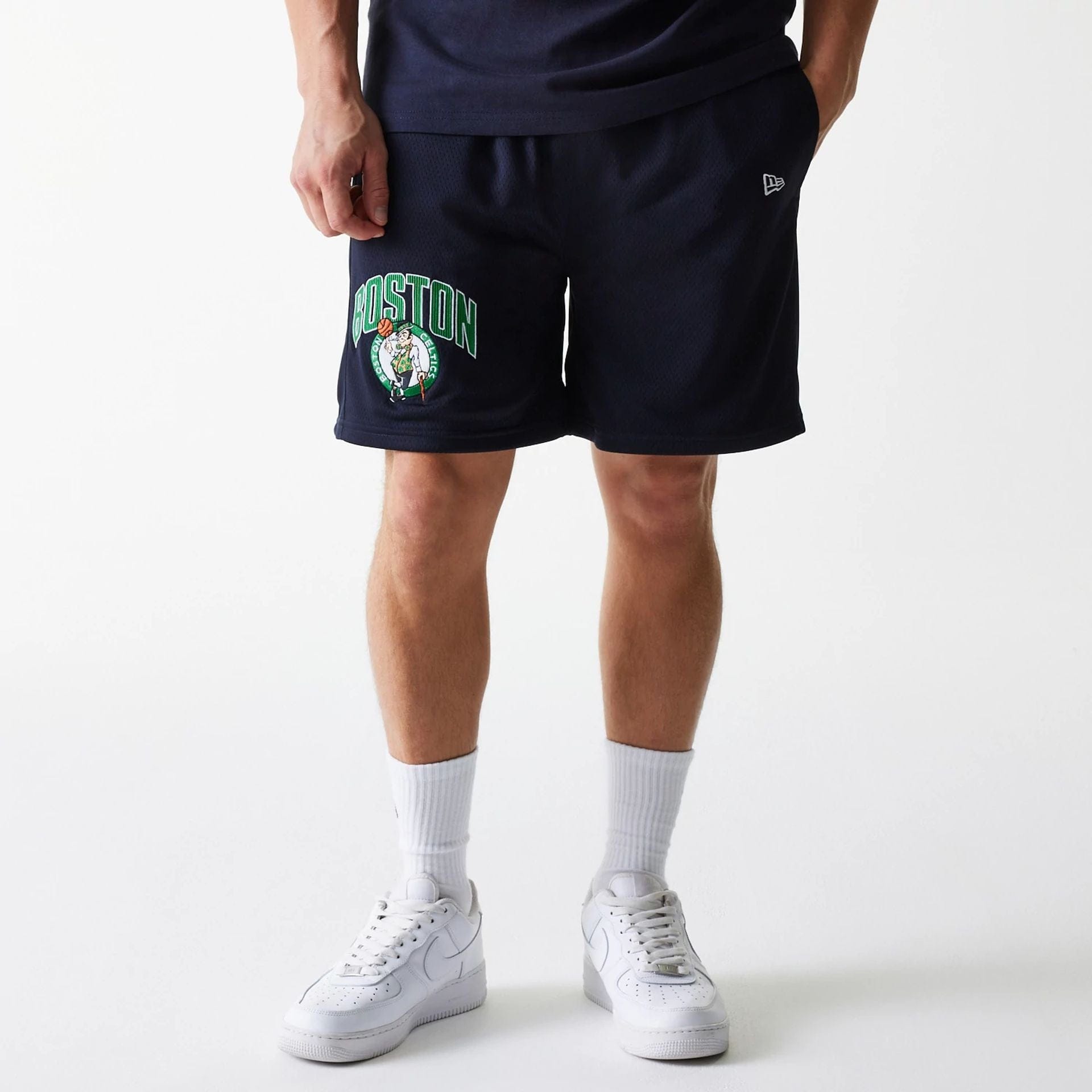The Male model is wearing Boston Celtics NBA Arch Graphic Navy Mesh Shorts 1