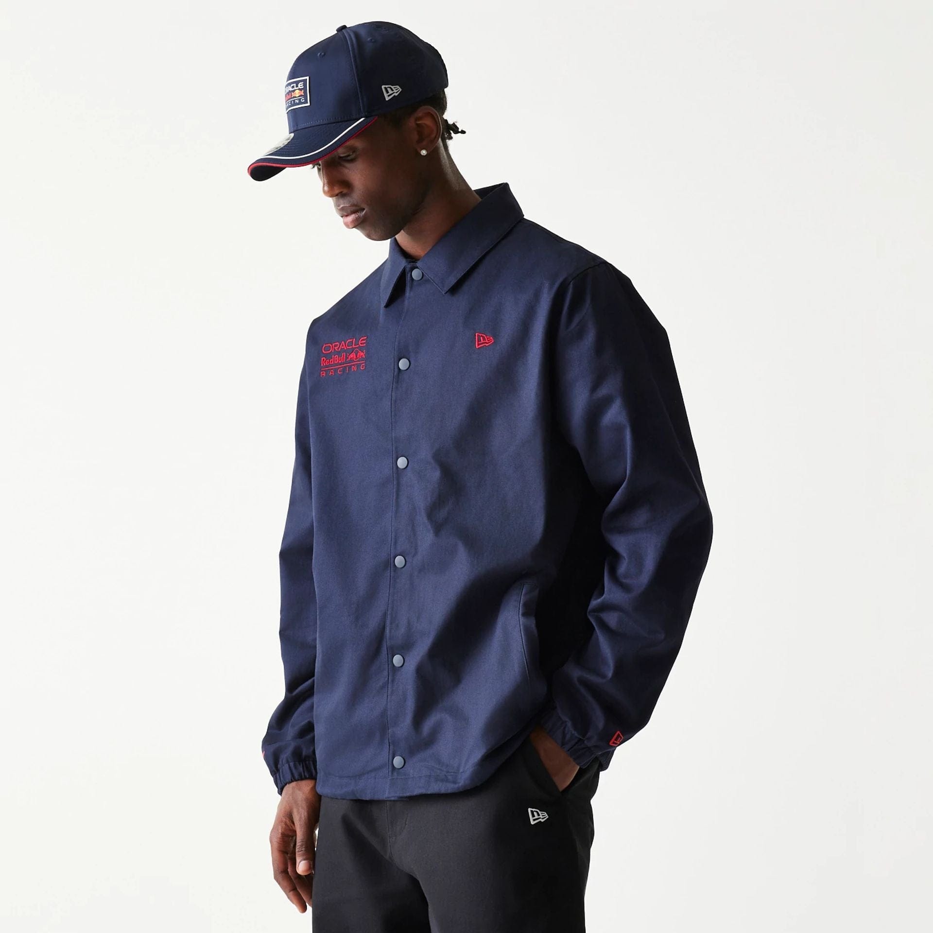 The Male model is wearing Red Bull Racing Dark Blue Oversized Coach Jacket 1
