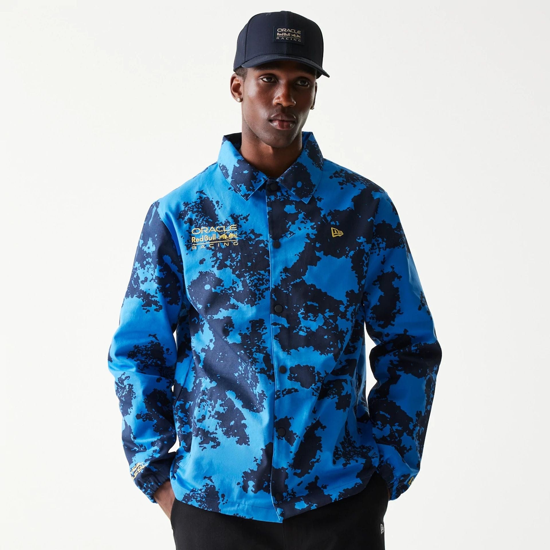 The Male model is wearing Red Bull Racing Blue Oversized Coaches Jacket 1