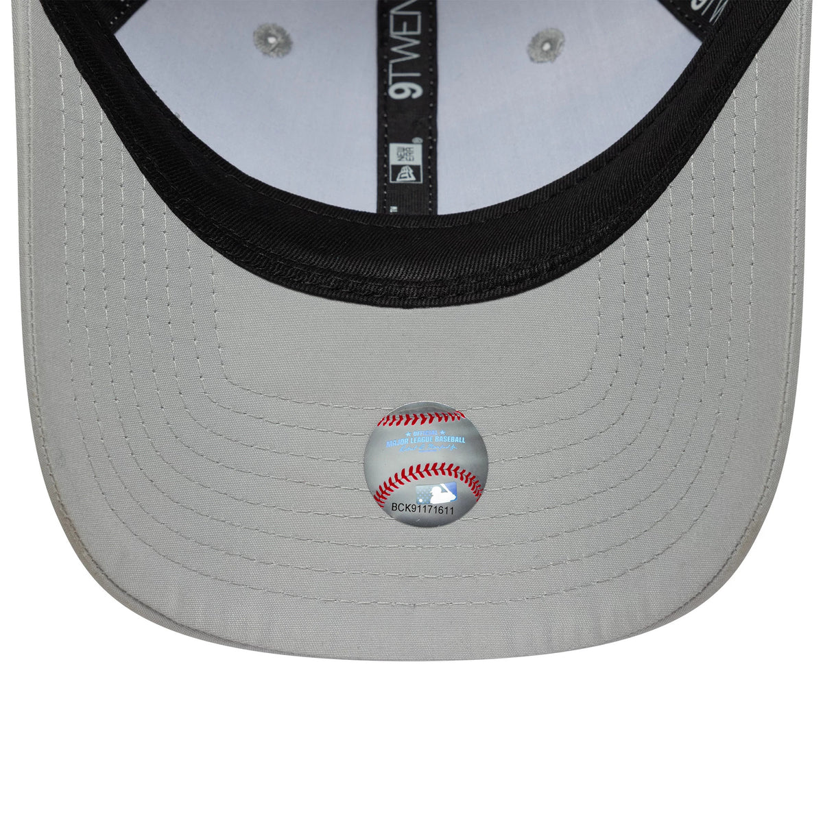 New York Yankees MLB Flawless Grey New Era 9TWENTY Adjustable Cap, inside view showing the black taping with 9TWENTY branding and a baseball hologram sticker on the underside of the grey visor.