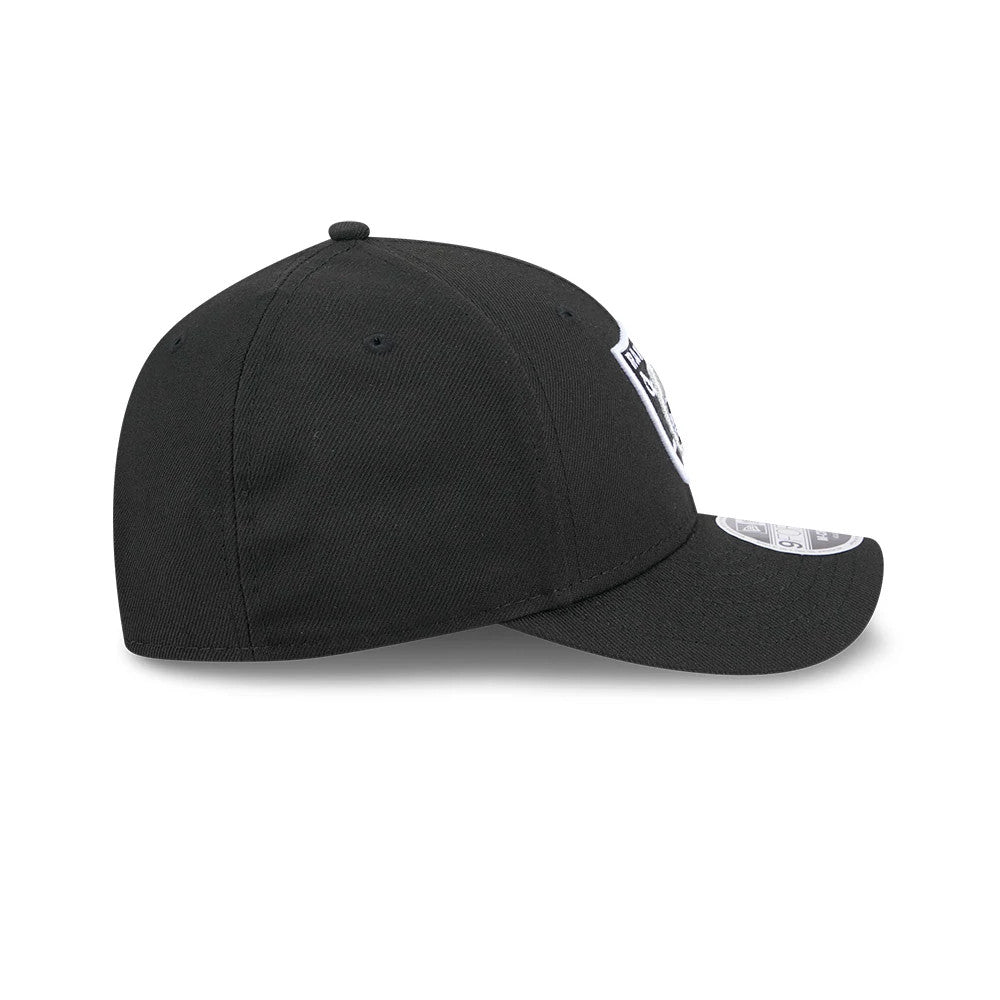 Las Vegas Raiders NFL Team Black New Era 9FORTY M-Crown Cap, side view showing the raised embroidered team logo on the front panel, black crown with matching top button and eyelets, and 9FORTY size sticker on the curved visor.