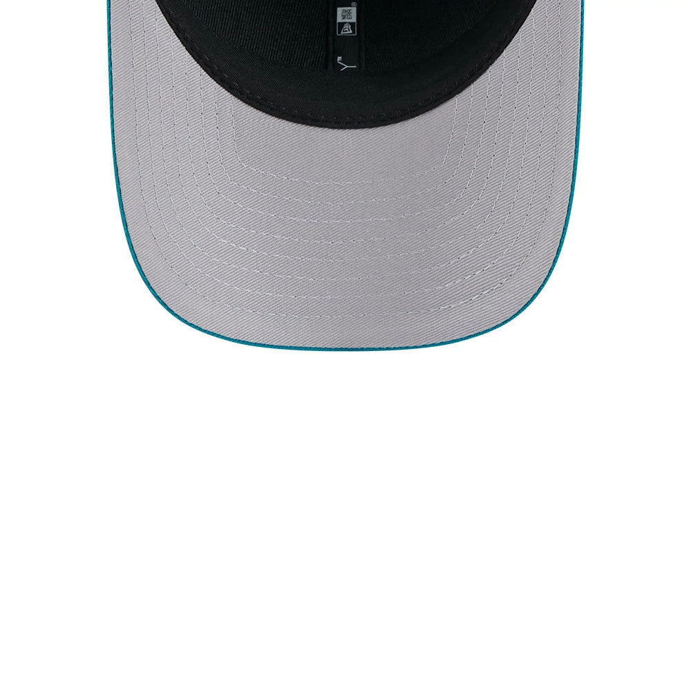Jacksonville Jaguars NFL Team Turquoise New Era 9FORTY M-Crown Cap, inside view showing a grey undervisor with turquoise edge stitching, and a black sweatband with size and care labels attached.