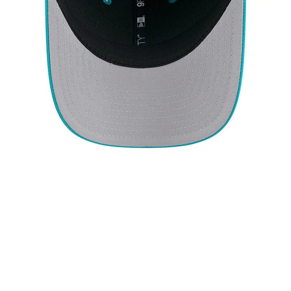 Miami Dolphins NFL Team Turquoise New Era 9FORTY M-Crown Cap, inside view showing grey undervisor with turquoise edging, black sweatband, and branded taping featuring the 9FORTY size sticker and New Era logo.