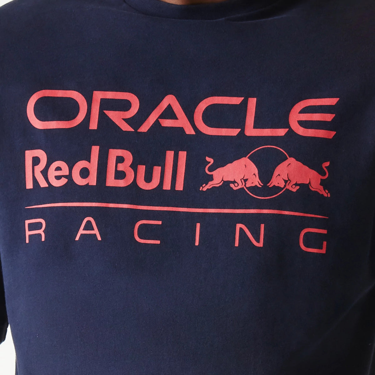 New Era Red Bull Racing Dark Blue Oversized T-Shirt, front view showing the printed logo with red Oracle branding above the Red Bull Racing emblem, featuring two bulls and a circle in matching red on the dark blue fabric.