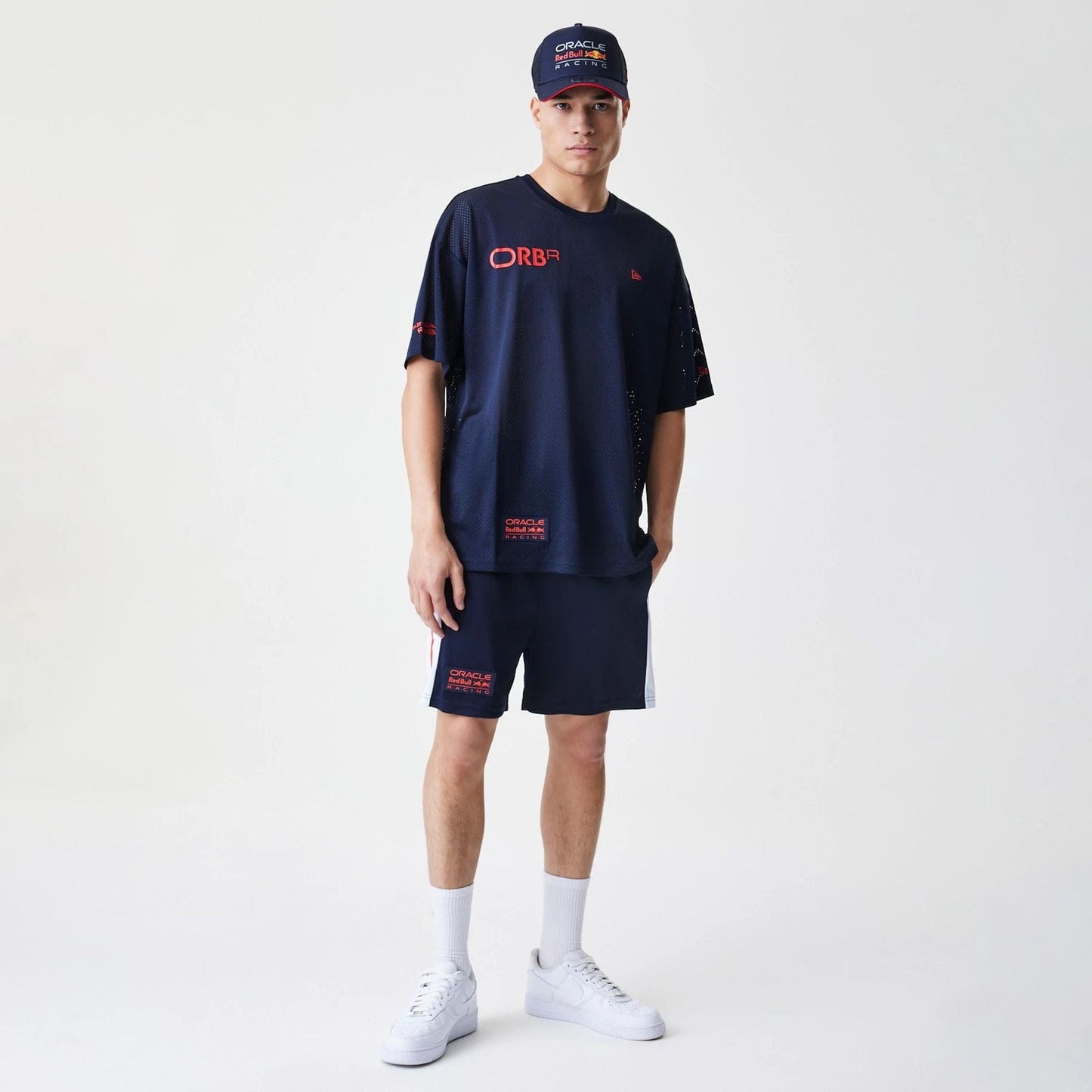 The Male model is wearing Red Bull Racing Graphic Mesh Dark Blue Oversized T-Shirt 8
