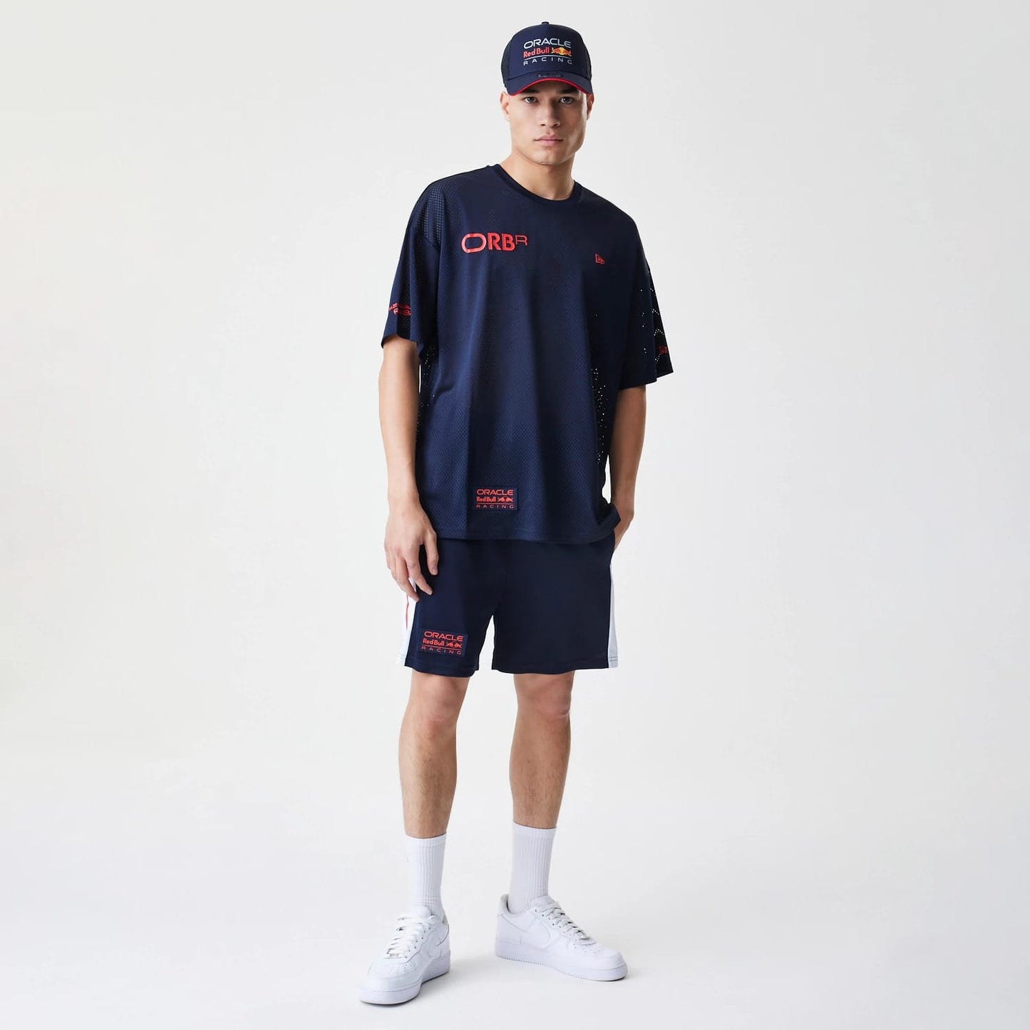 The Male model is wearing Red Bull Racing Graphic Mesh Dark Blue Oversized T-Shirt 8