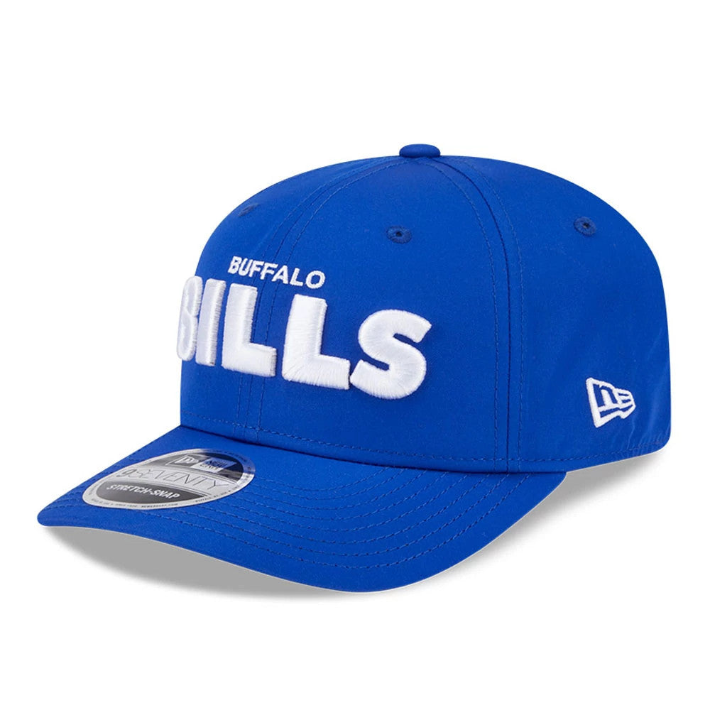 Buffalo Bills NFL Coach Blue New Era 9SEVENTY Stretch Snap Adjustable Cap, front view showing large raised white embroidered Bills lettering across the blue structured crown, with a curved visor and 9SEVENTY size sticker.